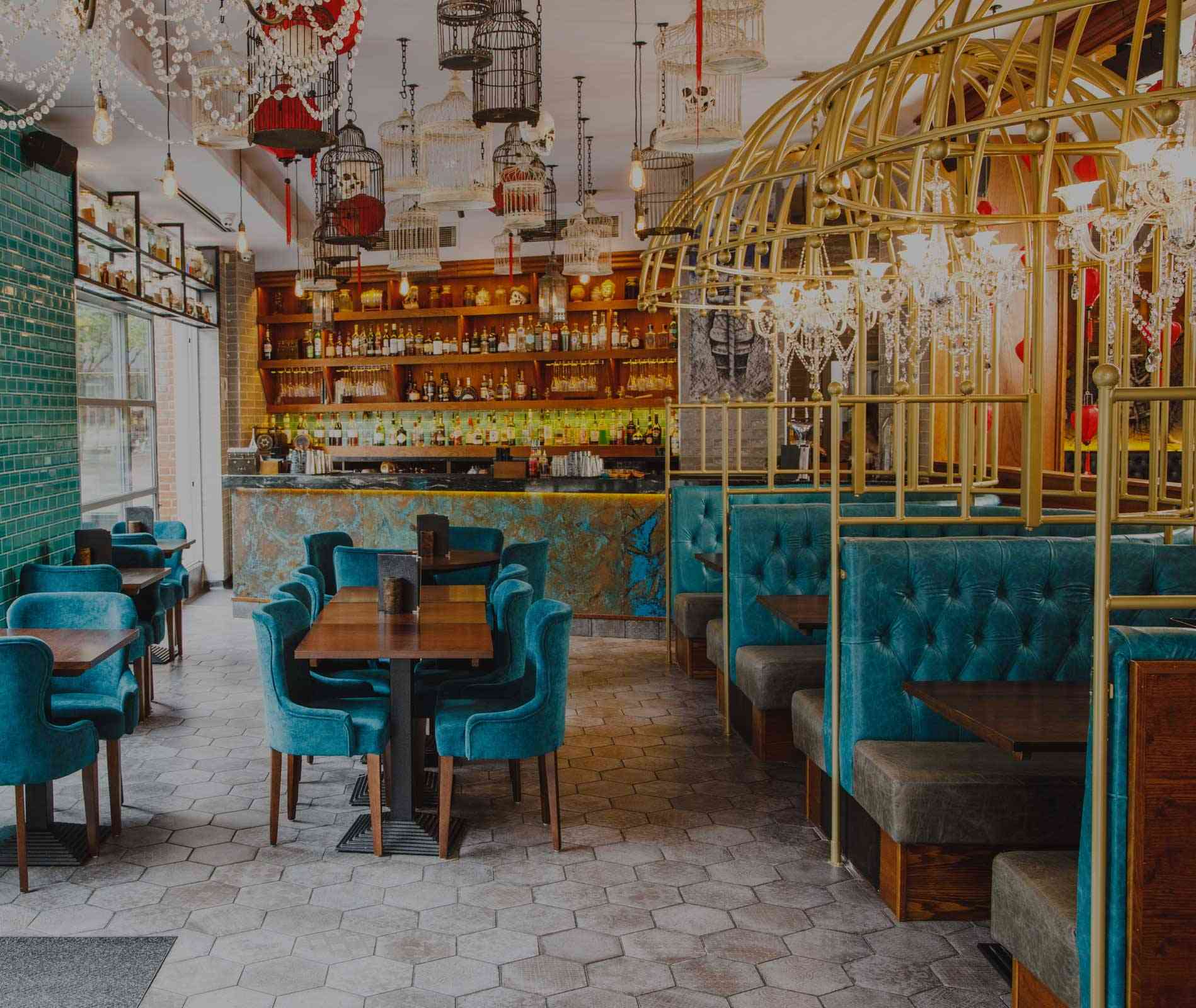 Teal velvet chairs, gold birdcage booths and the back-lit bar inside Siamais, Brindleyplace