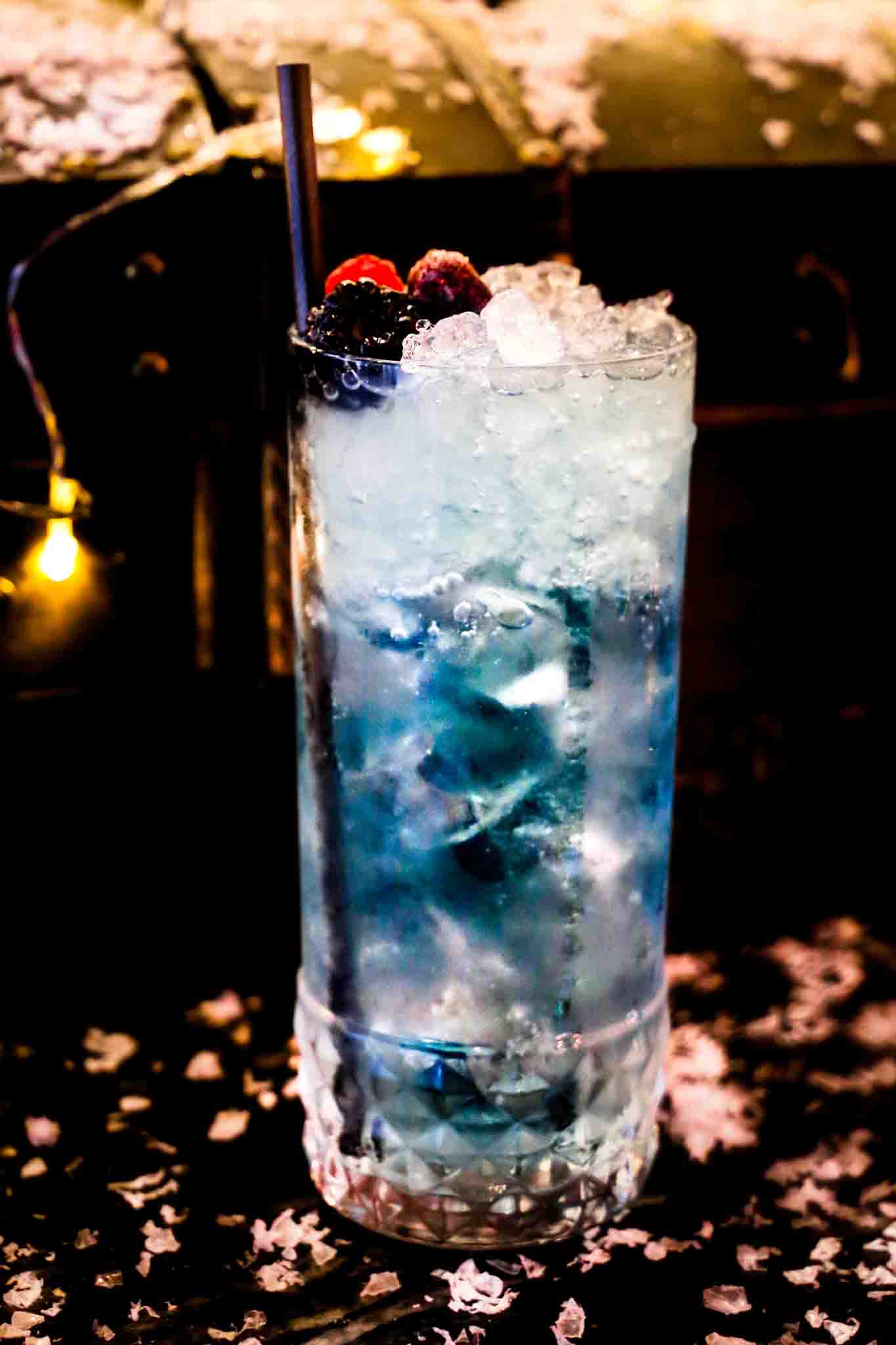 A blue Christmas cocktail over ice at Siamais